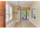 Bright breakfast nook with a cushioned bench, decorative lighting, and a view of the outdoor patio at 8408 Whispering Woods Ct, Lakewood Ranch, FL 34202