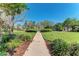 Charming gazebo with white railings in a lush green space, offering a serene view of the neighborhood and walking path at 8408 Whispering Woods Ct, Lakewood Ranch, FL 34202