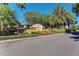 Edgewater Cove community sign with brick pillars surrounded by manicured landscaping and mature palm trees under a bright, clear sky at 8408 Whispering Woods Ct, Lakewood Ranch, FL 34202