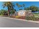 Edgewater Village community entrance featuring a stone sign and colorful landscaping, creating a welcoming impression at 8408 Whispering Woods Ct, Lakewood Ranch, FL 34202