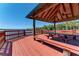 Comfortable gazebo with picnic tables overlooking the serene lake, surrounded by nature for tranquil outdoor dining at 8408 Whispering Woods Ct, Lakewood Ranch, FL 34202