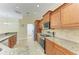 Well-equipped kitchen with granite countertops, tile backsplash, and stainless steel appliances at 8408 Whispering Woods Ct, Lakewood Ranch, FL 34202