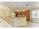 Modern kitchen with ample wood cabinetry, stone countertops, and an open layout at 8408 Whispering Woods Ct, Lakewood Ranch, FL 34202