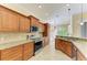 Spacious kitchen featuring granite countertops, stainless steel appliances, and tile flooring at 8408 Whispering Woods Ct, Lakewood Ranch, FL 34202