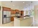 Modern kitchen with stainless steel appliances, granite countertops, and ample cabinet space at 8408 Whispering Woods Ct, Lakewood Ranch, FL 34202