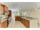 Open-concept kitchen with granite countertops and stainless steel appliances overlooking the living area at 8408 Whispering Woods Ct, Lakewood Ranch, FL 34202