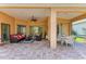 Expansive lanai showcases comfortable seating and dining areas, ideal for outdoor entertaining and relaxation at 8408 Whispering Woods Ct, Lakewood Ranch, FL 34202