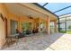 Spacious lanai with brick flooring, ceiling fan, and multiple seating areas for outdoor enjoyment at 8408 Whispering Woods Ct, Lakewood Ranch, FL 34202