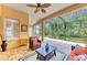 Comfortable lanai setting includes a ceiling fan, brick flooring, and screened enclosure with views of surrounding greenery at 8408 Whispering Woods Ct, Lakewood Ranch, FL 34202