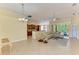 Open-concept living room with tile flooring, dining area, and view of the kitchen at 8408 Whispering Woods Ct, Lakewood Ranch, FL 34202