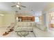 Spacious living room with tile flooring, open to the kitchen, and comfortable seating area at 8408 Whispering Woods Ct, Lakewood Ranch, FL 34202
