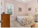 Cozy bedroom with pink walls features carpeted flooring and a large window at 8604 15Th Nw Ave, Bradenton, FL 34209