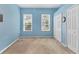 Comfortable bedroom with blue walls, carpeted flooring, and a double closet at 8604 15Th Nw Ave, Bradenton, FL 34209