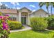 Close-up shot of the home's double door front entrance flanked by vibrant bougainvillea at 8604 15Th Nw Ave, Bradenton, FL 34209