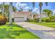 Charming home featuring a well-manicured lawn and beautiful tropical landscaping at 8604 15Th Nw Ave, Bradenton, FL 34209