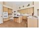 Well-lit kitchen features an island, wood floors and cabinets, and bright countertops at 8604 15Th Nw Ave, Bradenton, FL 34209