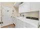 Functional laundry room features a washer, dryer, sink, and storage cabinets at 8604 15Th Nw Ave, Bradenton, FL 34209