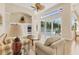 Bright living room with vaulted ceilings, fan, and view of enclosed pool at 8604 15Th Nw Ave, Bradenton, FL 34209