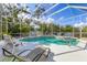 Screened-in pool with hot tub and poolside seating at 8604 15Th Nw Ave, Bradenton, FL 34209