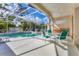 Screened-in lanai features a pool, spa, and an outdoor dining area with four chairs at 8604 15Th Nw Ave, Bradenton, FL 34209