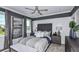 This bedroom features a plush headboard, serene colors, and large windows for ample natural light, creating a relaxing retreat at 8633 Snowfall St, Sarasota, FL 34241