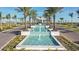 Beautiful entrance to a community with flowing fountains and rows of mature palm trees at 8633 Snowfall St, Sarasota, FL 34241