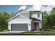 Charming two-story home with gray siding, a two-car garage and a well-manicured lawn at 8633 Snowfall St, Sarasota, FL 34241