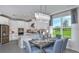 Open-concept kitchen featuring white cabinets, stainless steel appliances, and an adjacent dining area at 8633 Snowfall St, Sarasota, FL 34241