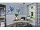 Bright office with a modern desk, stylish shelves, and a large window overlooking the landscaped yard at 8633 Snowfall St, Sarasota, FL 34241