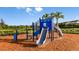 Community playground with blue and gray play structure and mulch, perfect for children to play at 8633 Snowfall St, Sarasota, FL 34241