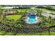 Aerial shot of a beautiful community pool with lounge chairs and lush landscaping at 8633 Snowfall St, Sarasota, FL 34241