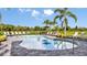 Community pool with plenty of lounge chairs and tropical landscaping, perfect for relaxing at 8633 Snowfall St, Sarasota, FL 34241