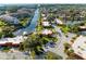 Expansive aerial view of waterfront community with docks, lush landscaping, and waterway access to the ocean at 9409 Catalina Dr, Bradenton, FL 34210