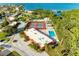 This aerial photograph shows the community tennis courts and swimming pool surrounded by trees at 9409 Catalina Dr, Bradenton, FL 34210