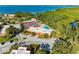 An aerial view showing tennis courts, a pool and wooded areas in the community at 9409 Catalina Dr, Bradenton, FL 34210
