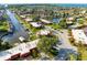 Expansive aerial view of waterfront community with docks, lush landscaping, and waterway access to the ocean at 9409 Catalina Dr, Bradenton, FL 34210