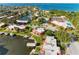 Aerial view of waterfront community with docks, marina, pool, and tennis courts on a sunny day at 9409 Catalina Dr, Bradenton, FL 34210