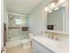 Bathroom featuring a vanity with marble countertop, a shower over tub with a sliding glass door at 9409 Catalina Dr, Bradenton, FL 34210