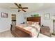 Spacious bedroom with a large bed and wood-look floors and an ensuite bathroom at 9409 Catalina Dr, Bradenton, FL 34210