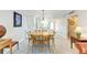 Bright dining room features a round table, modern lighting, and an open connection to the kitchen at 9409 Catalina Dr, Bradenton, FL 34210