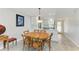 Bright dining room features a round table, modern lighting, and an open connection to the kitchen at 9409 Catalina Dr, Bradenton, FL 34210