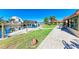 Community dock featuring boat slips, green space, and a paved walkway on the water's edge at 9409 Catalina Dr, Bradenton, FL 34210
