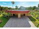 Spacious home featuring a brick driveway, carport, and lush landscaping, perfect for outdoor living and curb appeal at 9409 Catalina Dr, Bradenton, FL 34210