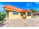 Exterior view of a red-roofed building with a grilling area and a paved outdoor area at 9409 Catalina Dr, Bradenton, FL 34210