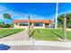 Exterior view of the building with a red roof, covered seating area and green lawn at 9409 Catalina Dr, Bradenton, FL 34210