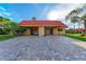 Inviting exterior view showcasing a well-maintained home with a brick driveway and carport providing ample parking at 9409 Catalina Dr, Bradenton, FL 34210