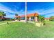 Charming single-story home with a vibrant lawn, mature palms and a cozy patio area for outdoor enjoyment at 9409 Catalina Dr, Bradenton, FL 34210