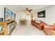 Cozy living room with sleek floors leads to an open kitchen and dining area, perfect for entertaining at 9409 Catalina Dr, Bradenton, FL 34210