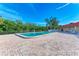 Community pool surrounded by a brick patio and lush landscaping at 9409 Catalina Dr, Bradenton, FL 34210