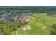 High aerial shot featuring the community clubhouse, pool, tennis courts, golf course and parking area at 9620 Club South Cir # 5304, Sarasota, FL 34238